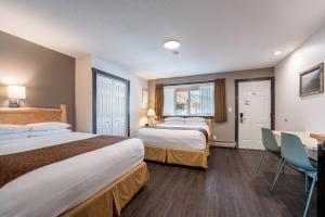 Postel nebo postele na pokoji v ubytování Swiss Chalet Motel