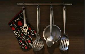 a group of utensils hanging on a wall at Flats Lago Norte MOTO CAPITAL 3 PESSOAS! in Brasilia +8 photos
