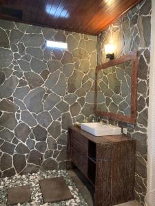 a bathroom with a sink and a mirror at Jenggala Hill in Nusa Lembongan