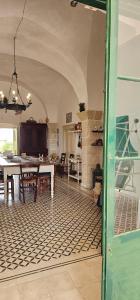 a kitchen and dining room with a table and chairs at Masseria Vivi il Salento in Santa Caterina di Nardò