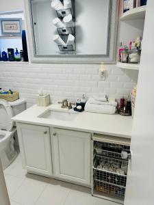 a bathroom with a sink and a toilet at Mathel and Mar in West Palm Beach +58 photos