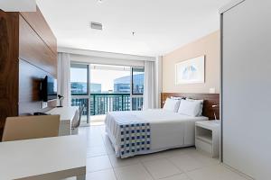 a hotel room with a bed and a balcony at Hotel VISION in Brasilia