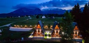 a large house with lights on the front of it at Villas Chardak in Žabljak