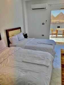Vuode tai vuoteita majoituspaikassa Anubis Pyramids View