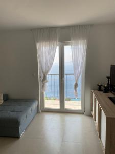 a bedroom with a bed and a large window at New 2 Bedroom, 2 Bathroom Apartment in Pisak in Pisak