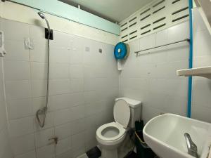 a bathroom with a toilet and a sink at Green Garden Hostel in Bangkok