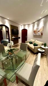 a living room with a couch and a glass table at Cosmopolitan PRAIA Flat com Estacionamento Grátis - Gonzaga - Ap 76 in Santos