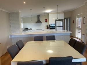 a kitchen with a table and chairs in a room at Waterside Mulwala in Mulwala