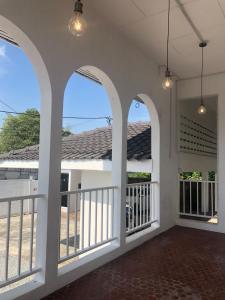 a porch of a house with arched windows at Calma Villa Jalan Sultanah in Alor Setar