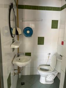a bathroom with a toilet and a sink at Vientiane Star Hotel in Vientiane