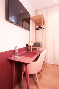 TV a/nebo společenská místnost v ubytování Rosa Hotel