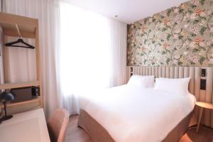 Postel nebo postele na pokoji v ubytování Rosa Hotel + 18 fotografií