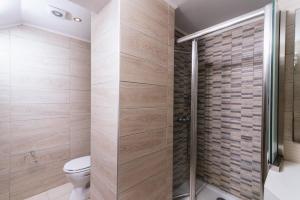 a bathroom with a toilet and a shower at Matala Bay in Style Apartments in Matala