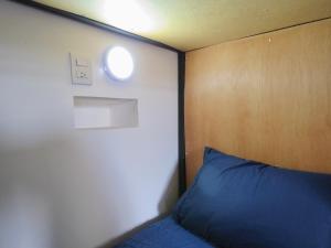 a bed with a blue pillow in a room at Hostal Centro Histórico in Oaxaca City +12 photos