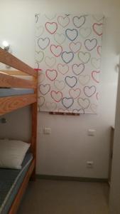 a bedroom with a wall with hearts painted on the wall at Saint-Geniez d'Olt - Résidence Le Colombier in Saint-Geniez-dʼOlt