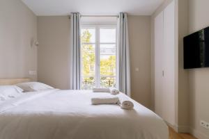 Posteľ alebo postele v izbe v ubytovaní Relaxing Studio Apartment in the Heart of Paris