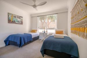 a bedroom with two beds and a window at La Grande Apartments in Gold Coast +152 photos