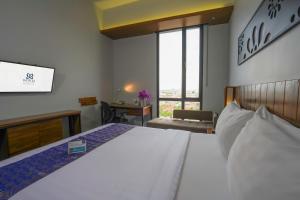 Ένα ή περισσότερα κρεβάτια σε δωμάτιο στο BATIQA Hotel Palembang