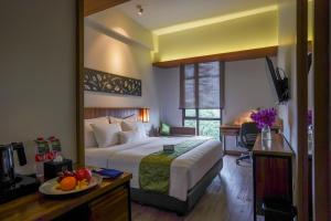 Ένα ή περισσότερα κρεβάτια σε δωμάτιο στο BATIQA Hotel Palembang
