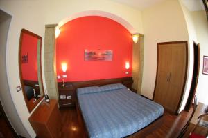 Ένα ή περισσότερα κρεβάτια σε δωμάτιο στο Hotel Nettuno