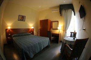 Ένα ή περισσότερα κρεβάτια σε δωμάτιο στο Hotel Nettuno