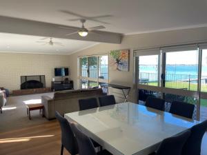 a living room with a table and chairs and a couch at Waterside Mulwala in Mulwala