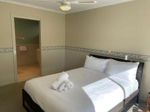 a bedroom with a bed with two towels on it at Waterside Mulwala in Mulwala