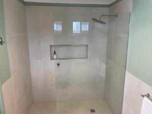 a shower with a glass door in a bathroom at Waterside Mulwala in Mulwala