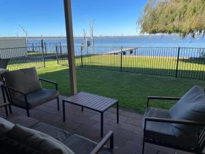 a patio with a couch and chairs and a table at Waterside Mulwala in Mulwala