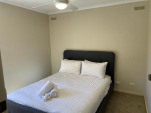 a bedroom with a bed with a stuffed animal on it at Waterside Mulwala in Mulwala