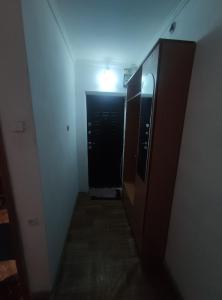 a hallway with a black door and a light at Однокомнатная квартира недалеко от озера Балхаш in Balqash