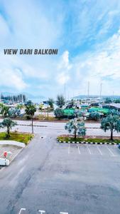 an empty parking lot with trees in a parking lot at D'Marina 2 HOMESTAY LUMUT MANJUNG in Lumut