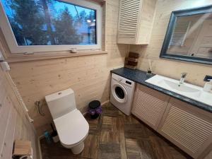 a small bathroom with a toilet and a sink at Siemiany Michałówka in Siemiany +51 photos