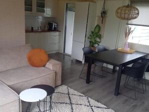 a living room with a couch and a table with chairs at Holiday Home in Grou near Cycling Route in Grou +30 photos