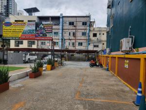 an empty parking lot in a city with buildings at The Pattaya Sports Hub in Pattaya Central