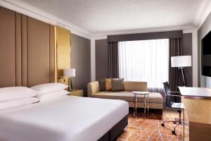 a hotel room with a bed and a couch at Brisbane Marriott Hotel in Brisbane