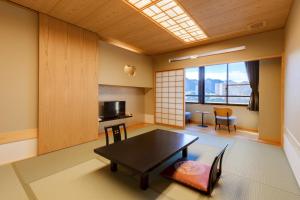 a living room with a table and a window at Ishikin in Gifu
