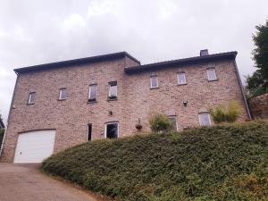 a large brick building on top of a hill at La Maison des Senteurs in Francorchamps