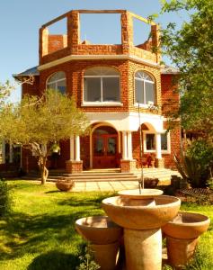 a red brick house with two large pots in front of it at Ouhave Country Home in Imkerhof +20 photos