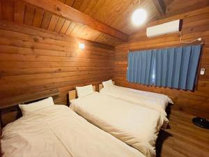 Voodi või voodid majutusasutuse Aso Lodge Otohime II toas