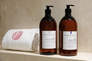 two bottles of wine sitting on a shelf next to a towel at Finca Sa Sort in Santanyi