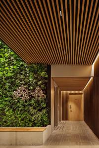 a hallway with a large green wall at Skostredet Hotel in Bergen