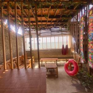 a room with a table and a bench in a building at HiGhLanDer SeAsuN in San Fernando