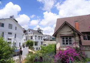 a group of white houses in a city at MENTO Villa Đà Lạt in Da Lat