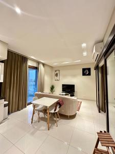 a living room with a table and a couch at 2 Hawana VIP Studio in Ma‘mūrah