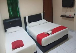 Postel nebo postele na pokoji v ubytování Hotel Iskandar Perak