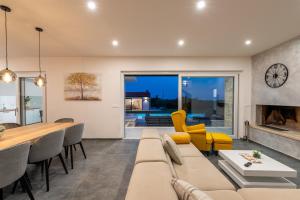 a living room with a couch and a table at Beautiful Villa Brtonigla with pool in Brtonigla in Brtonigla