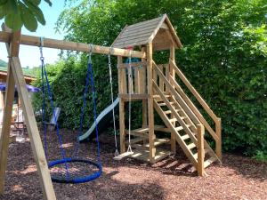 a playground with a slide and a swing at Hinkelshof - als Ferienwohnung - Selbstversorgerküche & Aufenthaltsräume - Südeifel, Mullerthal, Vianden in Körperich