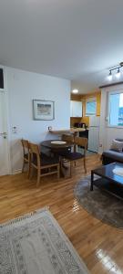 a living room with a couch and a table and chairs at Apartment Mia in Sarajevo