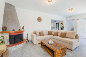 a living room with a couch and a fireplace at Villa Bella Natura in Afantou +27 photos